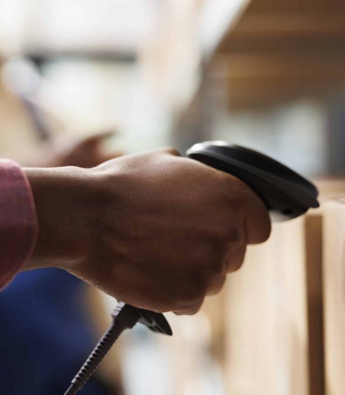 African american storehouse employee arm using barcode scanner