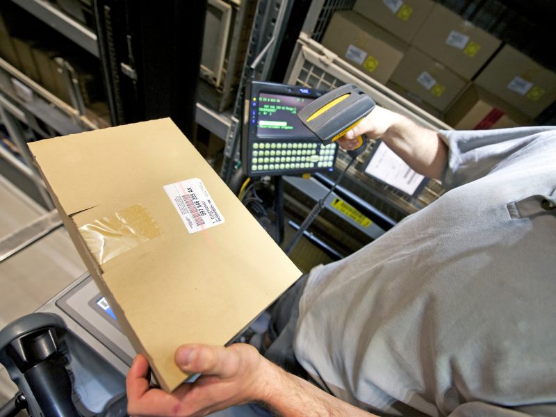 Automated warehouse. Boxes with spare parts moving on conveyer